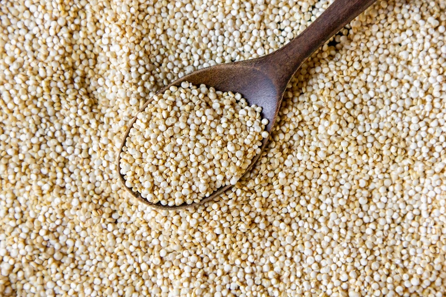 Top view quinoa with a wooden spoon
