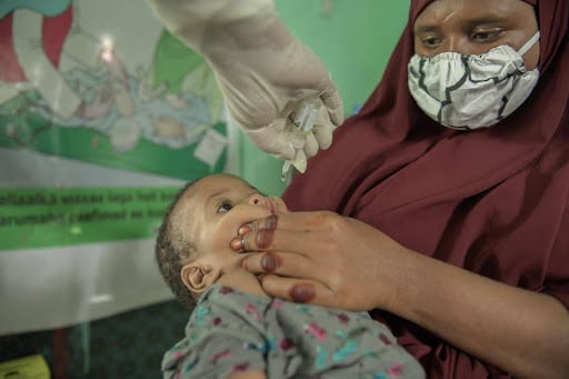 Child receiving Polio vax in Angola
